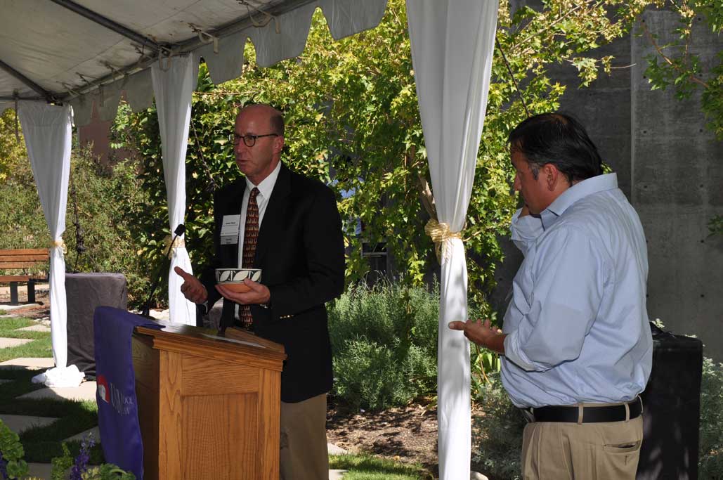 Modrall Scholarship recipient Pablo Padilla presents a Zuni Pueblo bowl to firm president Walter Stern.